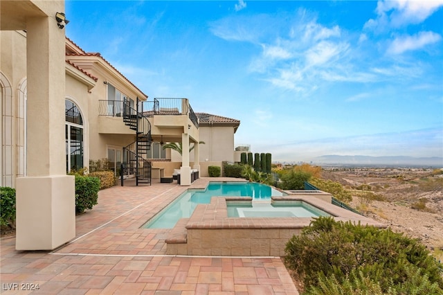 view of swimming pool with a patio area and an in ground hot tub