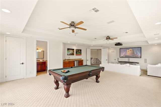 rec room with a tray ceiling, light carpet, and billiards