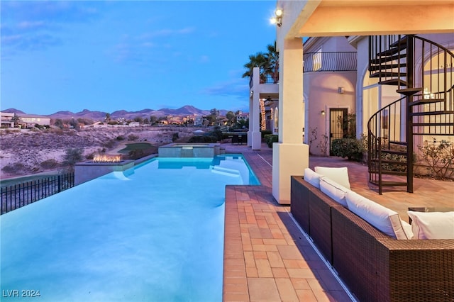 view of pool with a mountain view, an outdoor hangout area, an in ground hot tub, and a patio area