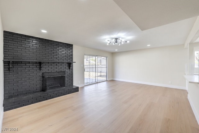 unfurnished living room with a fireplace and light wood-type flooring