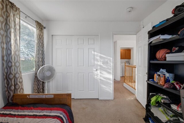 bedroom with a closet and light colored carpet