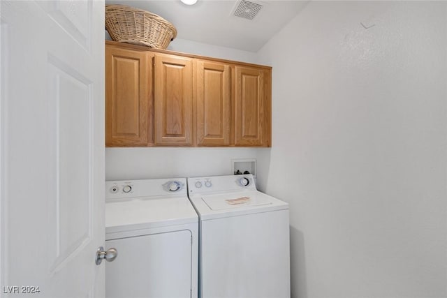 washroom featuring cabinets and washing machine and dryer