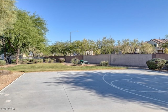 view of basketball court with a lawn