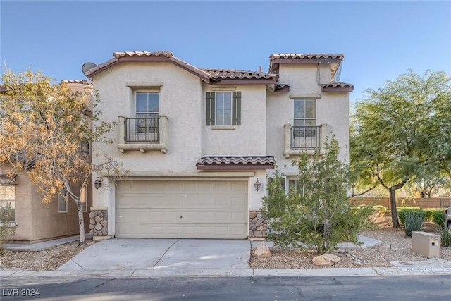 mediterranean / spanish-style home with a balcony and a garage