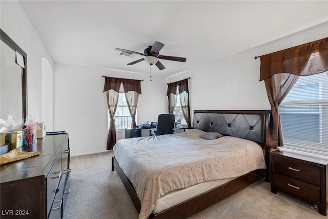 bedroom featuring light carpet and ceiling fan