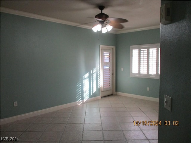 tiled empty room featuring crown molding and ceiling fan