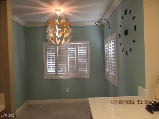 dining space featuring tile patterned flooring, an inviting chandelier, and crown molding