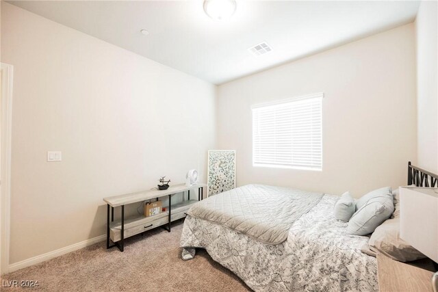 bedroom with light colored carpet