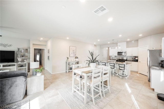 dining space featuring light tile patterned flooring