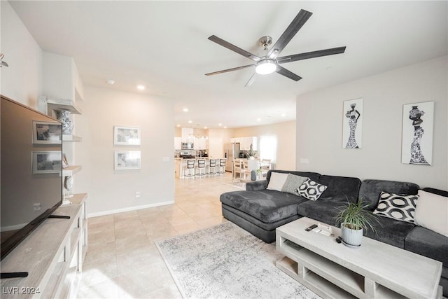 living room featuring ceiling fan and light tile patterned floors