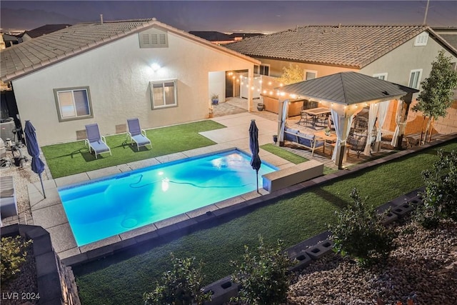 pool at dusk with a patio