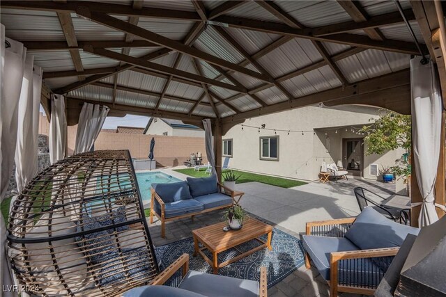 view of patio featuring a gazebo, an outdoor living space, and a fenced in pool