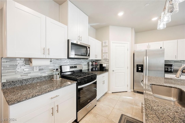 kitchen featuring white cabinets, backsplash, sink, and stainless steel appliances