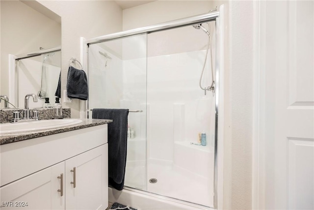 bathroom with vanity and a shower with shower door