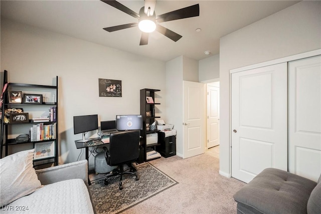 home office featuring light carpet and ceiling fan