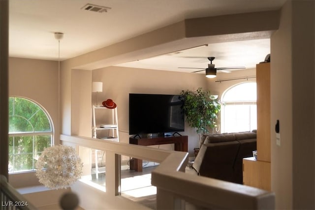 living room with plenty of natural light and ceiling fan