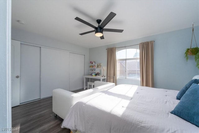 bedroom with dark wood-type flooring, a closet, and ceiling fan