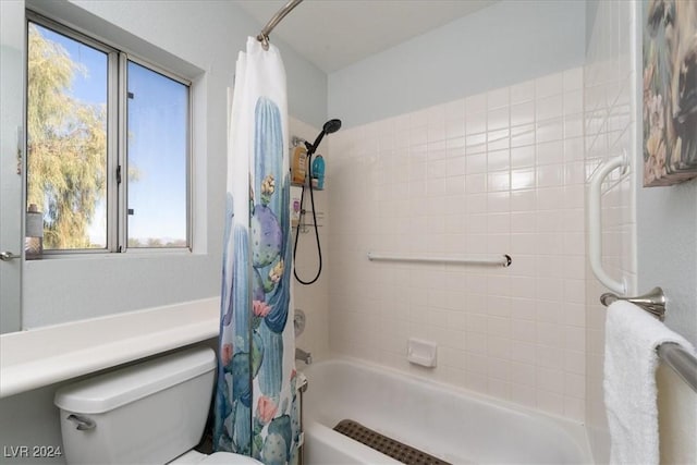 bathroom featuring shower / tub combo and toilet