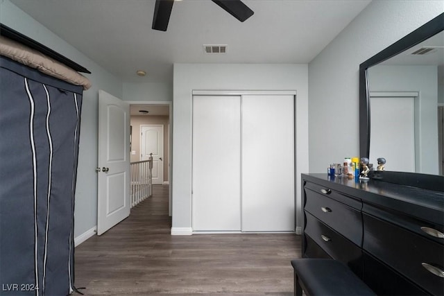 bedroom with dark wood-type flooring, a closet, and ceiling fan