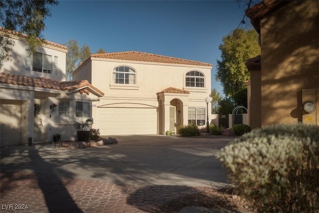 mediterranean / spanish home with a garage