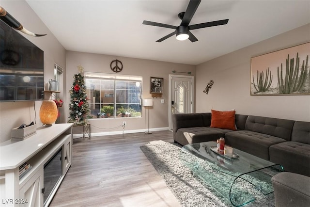 living room with wood-type flooring and ceiling fan