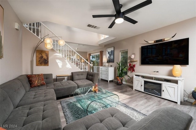 living room featuring hardwood / wood-style floors and ceiling fan