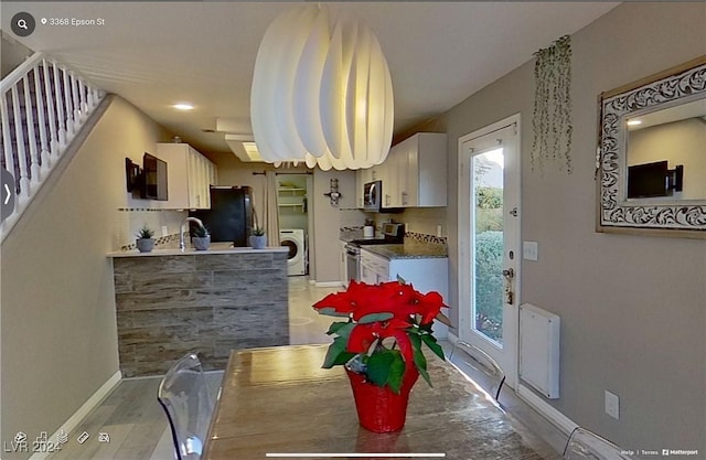 dining area featuring sink, washer / clothes dryer, and light hardwood / wood-style floors