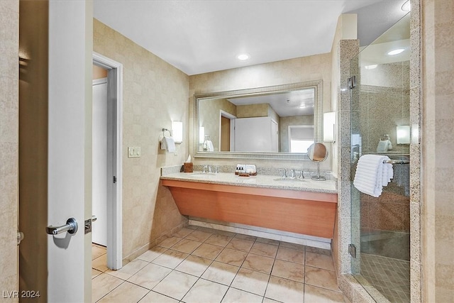 bathroom with tile patterned floors, vanity, and an enclosed shower