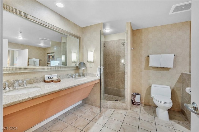 bathroom featuring tile patterned floors, toilet, an enclosed shower, and vanity