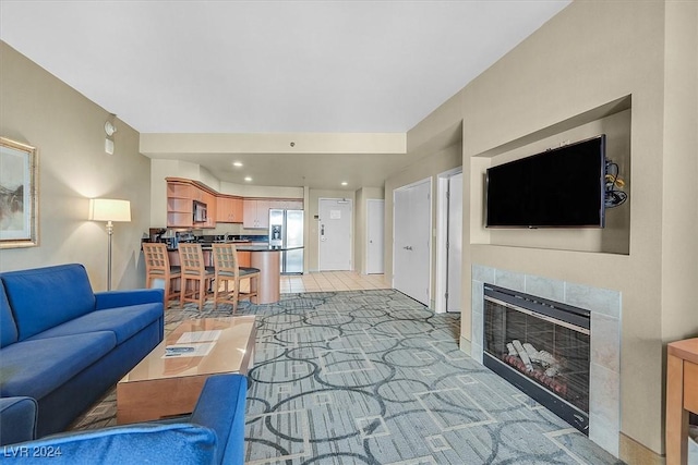 tiled living room with a tile fireplace