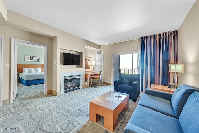 living room featuring a tile fireplace and carpet floors