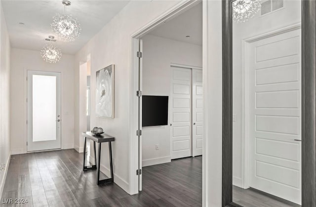 entryway with a chandelier and dark hardwood / wood-style flooring