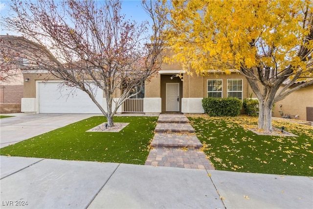 view of front of home with a front lawn and a garage