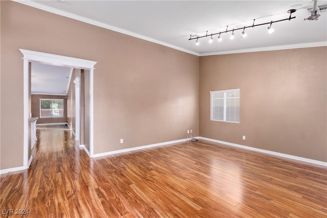 unfurnished room with hardwood / wood-style floors, rail lighting, and crown molding