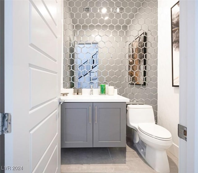 bathroom featuring tile patterned floors, vanity, and toilet