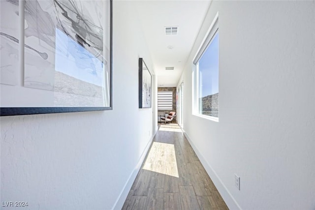 corridor with hardwood / wood-style floors