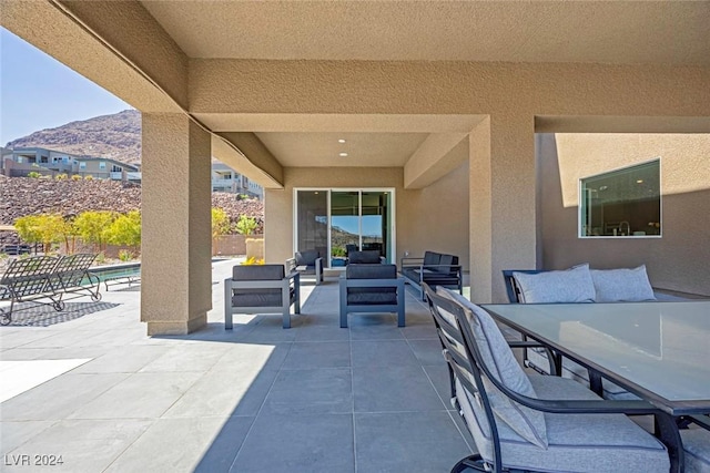 view of patio featuring a mountain view and an outdoor living space