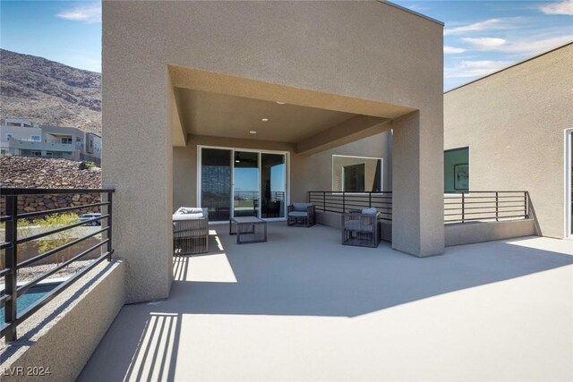 exterior space featuring a mountain view and a balcony