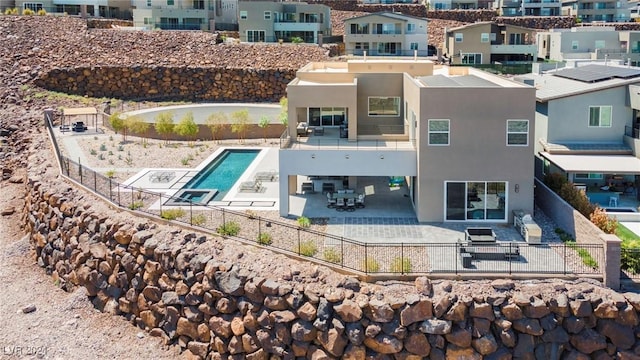 back of property featuring a fenced in pool and a patio area