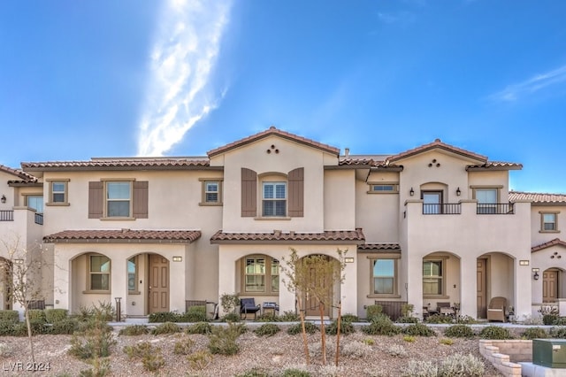 mediterranean / spanish-style home featuring a balcony