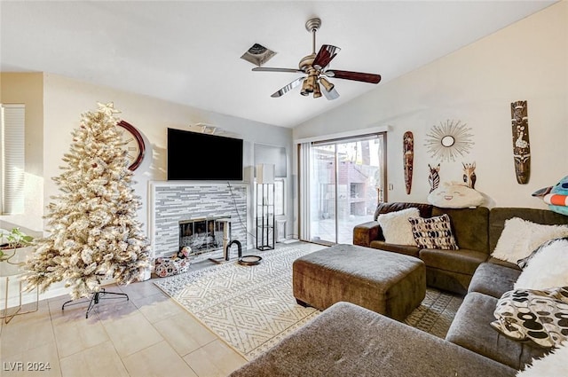 living room with ceiling fan, a fireplace, and vaulted ceiling