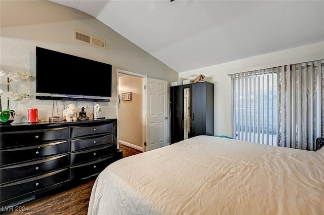 bedroom featuring dark hardwood / wood-style flooring and vaulted ceiling