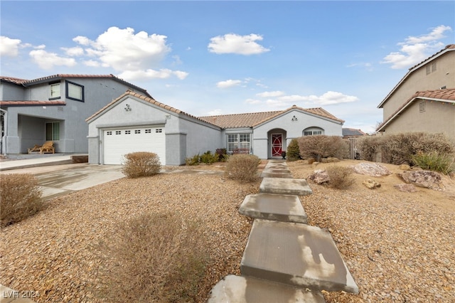 mediterranean / spanish-style home with a garage