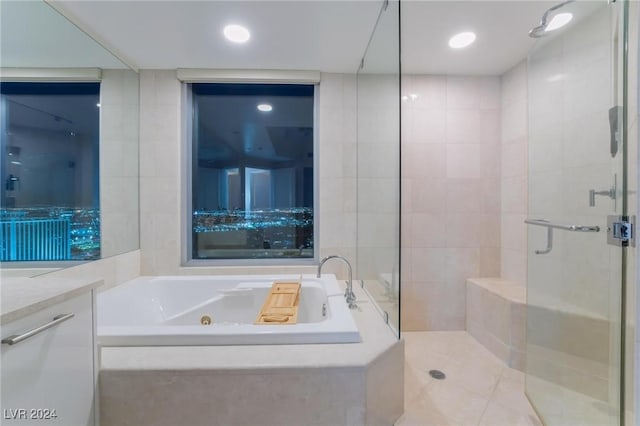 bathroom with vanity, tile walls, and plus walk in shower