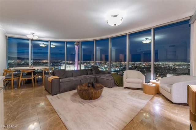 living area with expansive windows and marble finish floor
