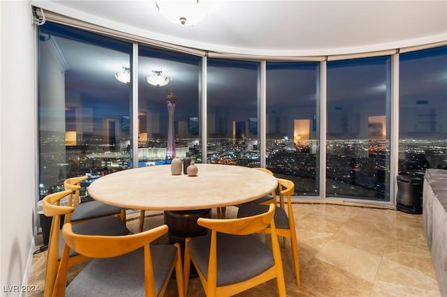 dining space featuring a view of city lights