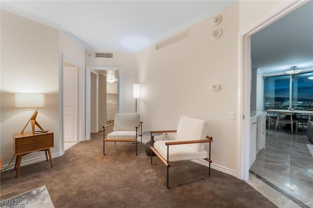 living area featuring crown molding and dark carpet