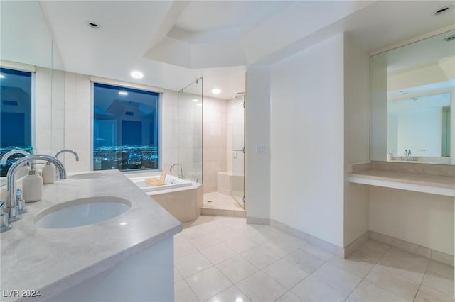 bathroom featuring tile patterned flooring, vanity, and shower with separate bathtub