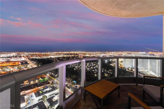 balcony at dusk with a view of city