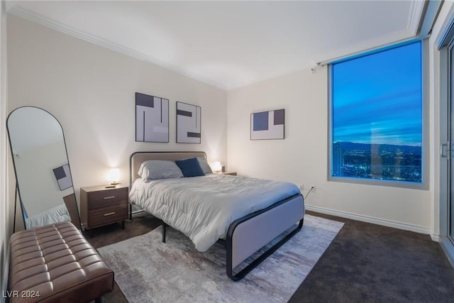 bedroom with dark carpet, baseboards, and ornamental molding